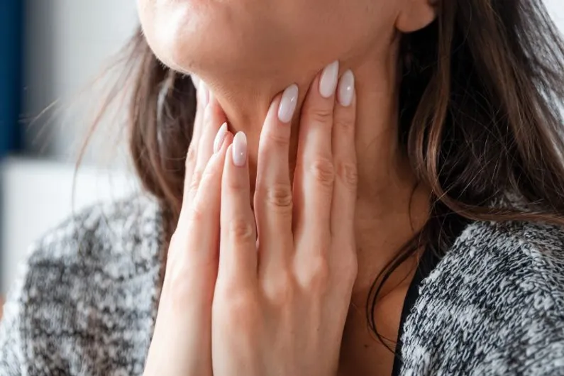 Woman holding her neck