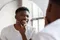 Man looking in mirror at his skin